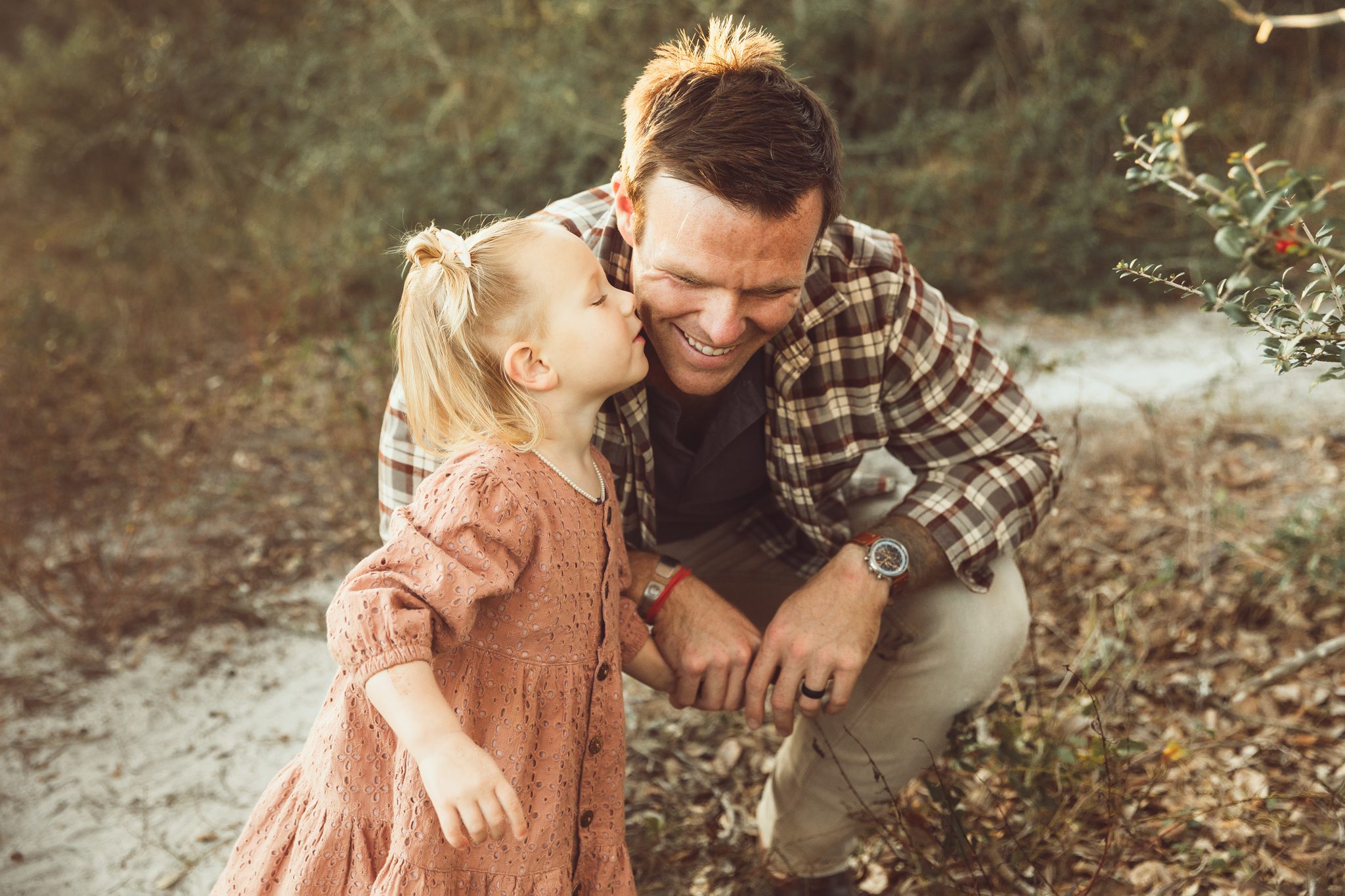 daughter giving daddy a kiss on the cheek